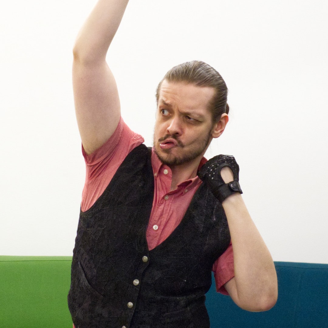 Man doing an uppercut punch with a funny face.