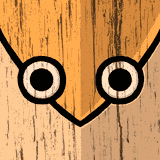 Wood carving resembling an owl's face.