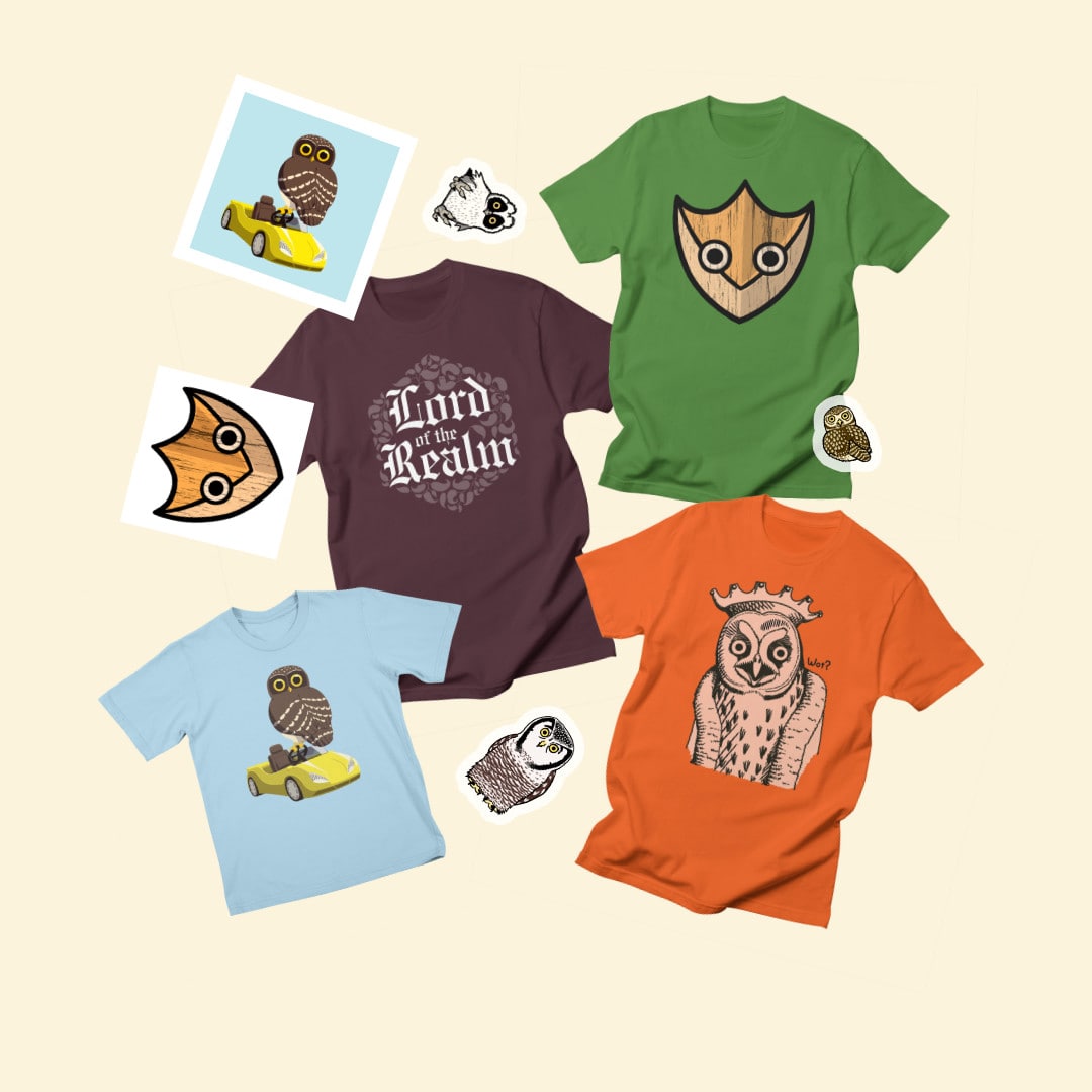 Bunch of different owl-themed shirts, paper prints and stickers laid out.